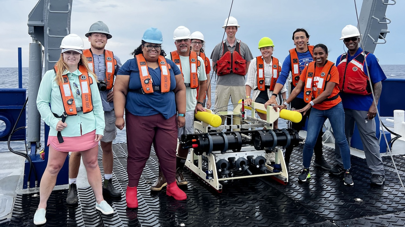 A group of SkIO scientists and Johnson High School educators stand on the back deck of the R/V Savannah.
