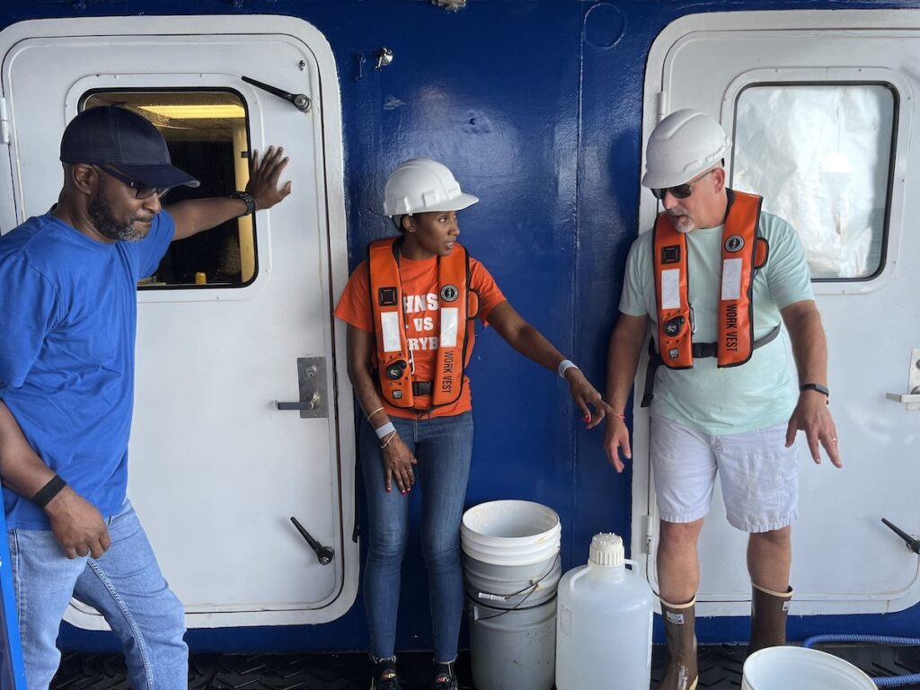 JHS educators Carlton Middleton (left) and Aasha Beard (center) work on the back of the R/V Savannah with Dr. Marc Frischer.